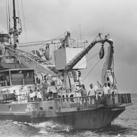Argo exchanging seismic records. People on the two ships photograph each other and shout friendly insults as though they had been separated for months instead of days.