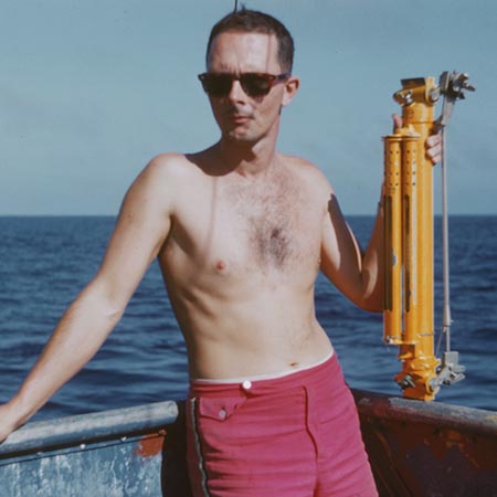 Jan B. Lawson of the Scripps Institution of Oceanography's Swan Song Expedition (1961) is shown here ready with a Nansen bottle to store the collection sample aboard the R/V Argo. This expedition explored the North Pacific at the equator and Eastern Tropical Pacific on the research ship Argo. The expedition collected large water samples for analysis, studied the Cromwell Current (Pacific Equatorial Undercurrent), and undertook a limited biological program for the Inter-American Tropical Tuna Commission. 1961.